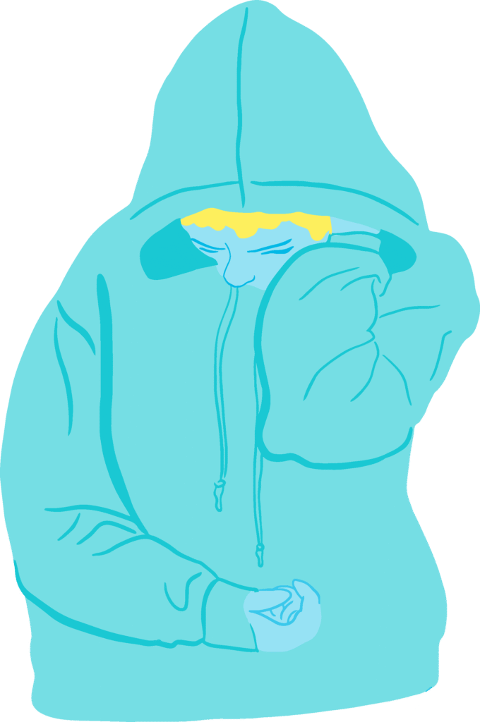 Boy in a blue hoodie with head down, face partly covered, and one hand clenched in front.