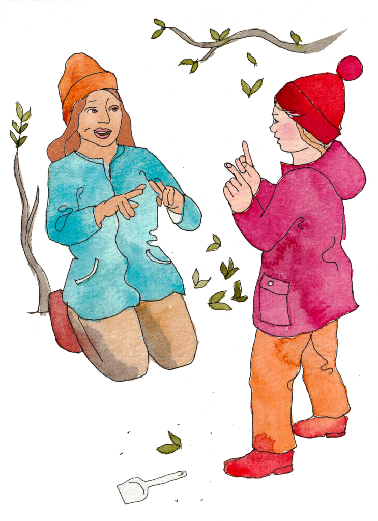 En vuxen och ett barn som talar teckenspråk.